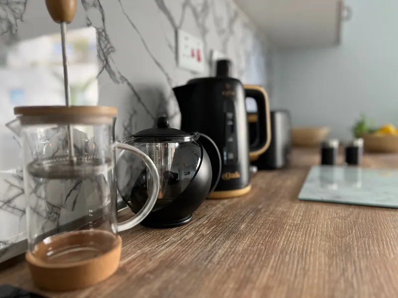 Kitchen worktop with a kettle, teapot and cafetière
